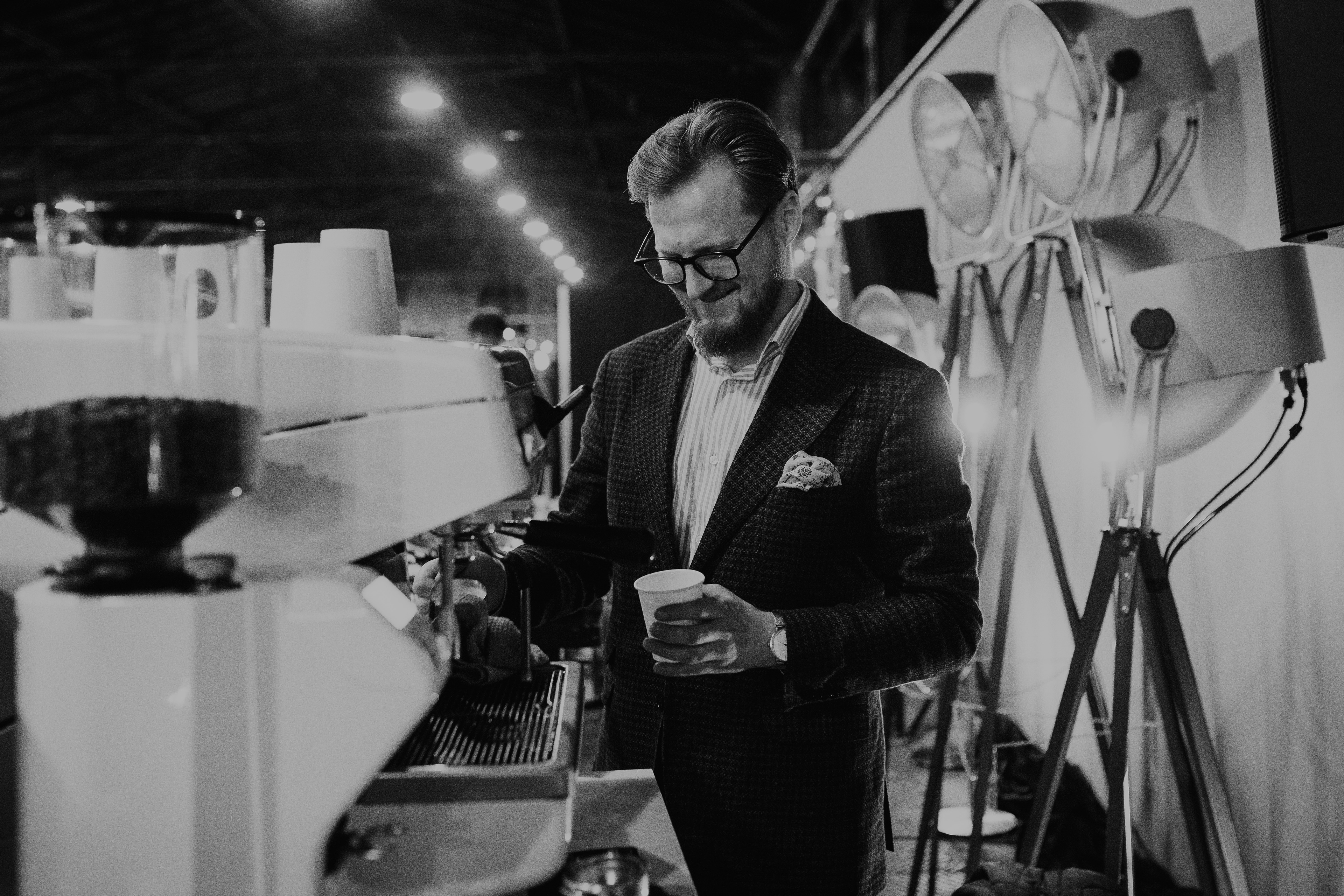 Portrait of the founder, a person pouring milk into a coffee cup